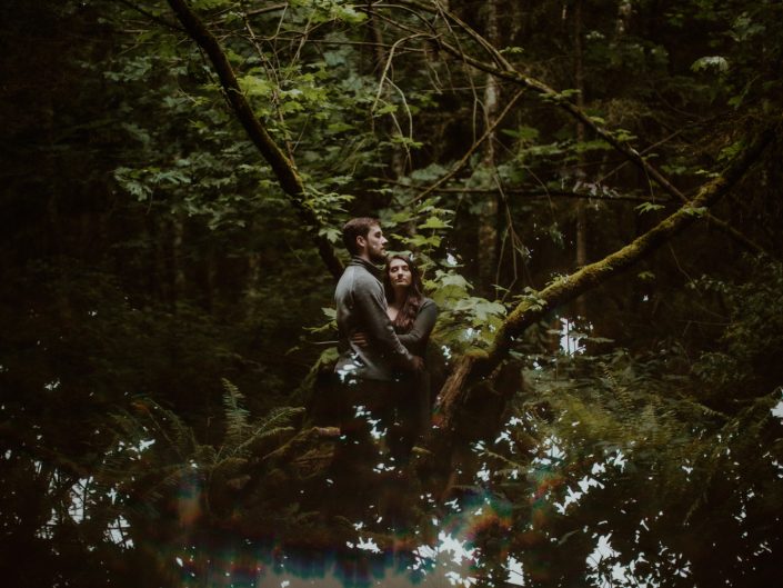 man and woman with eyes closed in trees